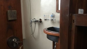 A wooden door with a keyhole and a towel hanging on a hook. - Perjuangan Boat 2 (Labuan Bajo)
