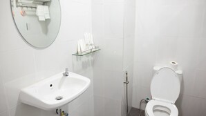 A bathroom with a white sink, a mirror, a toilet, and a glass shelf with toiletries. - Hpa An Boutique Inn (Hpa-An)