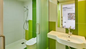 A bathroom with a glass-enclosed shower, a white sink, and a toilet. - APARTMENT (5 ADULTS ) POOL VIEW (L'Estartit)