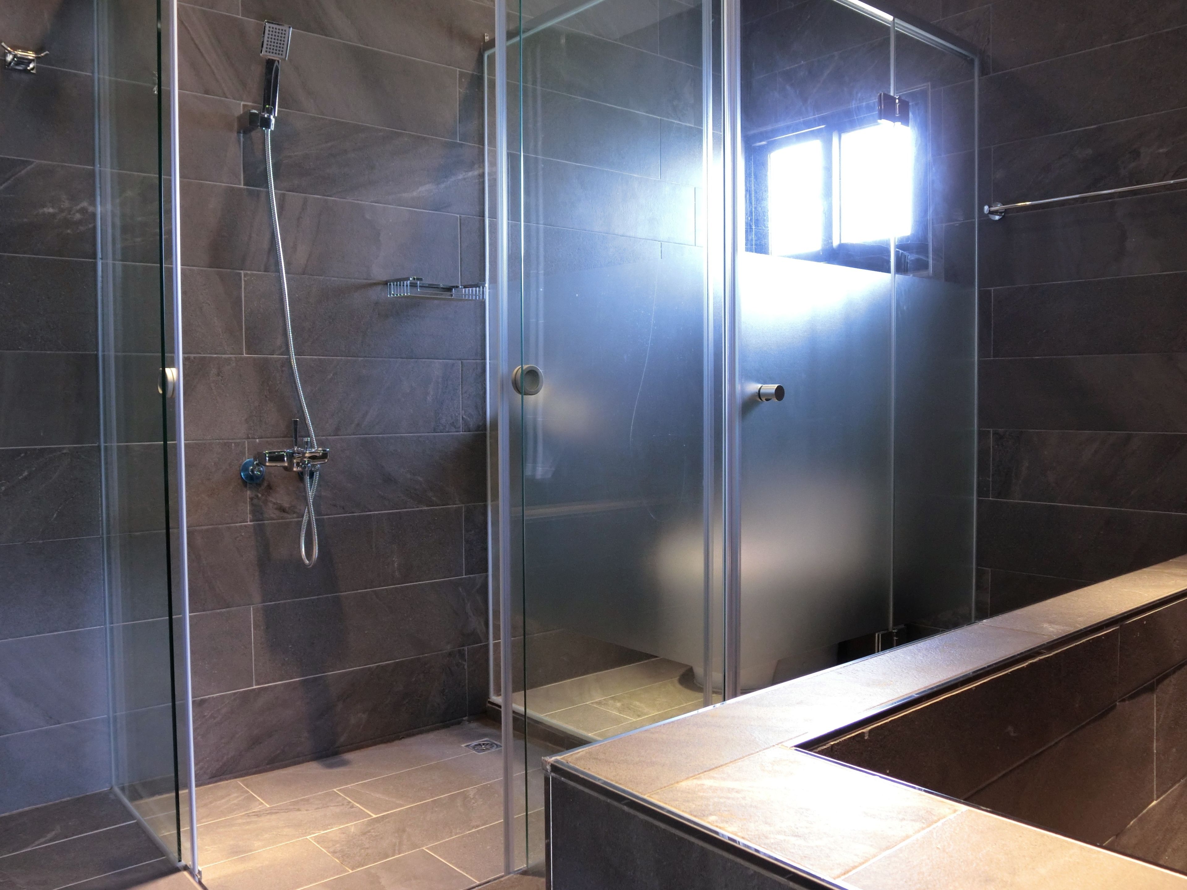 Shower, designer toiletries, hair dryer, slippers