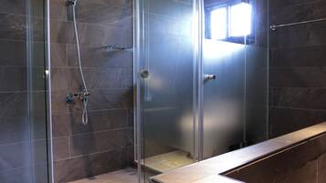 Shower, designer toiletries, hair dryer, slippers