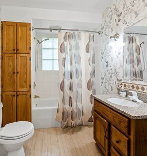 Bathtub, hair dryer, towels, shampoo