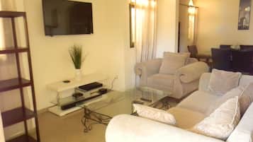 Exclusive Villa | Living room | 49-inch Smart TV with cable channels, TV, Netflix