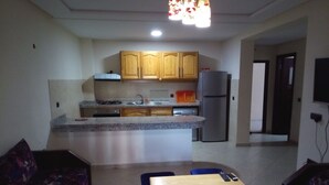 Un espacio habitable pequeño con cocina, comedor y sofá.