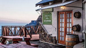 A rustic building with a sign stating it's the highest pub in Africa at 2874 meters. - Sani Mountain Lodge (Sani Pass)