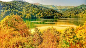 A serene lake surrounded by lush green hills.