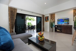 Deluxe Apartment, 2 Bedrooms, Terrace, Partial Sea View | Living area | Flat-screen TV - Baan Chom View Kamala (Kamala)