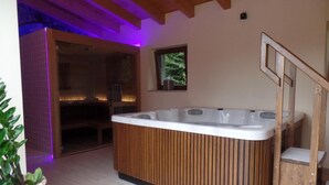 A modern bathroom with a wooden bathtub, a small window, and a staircase. - Il Vagabondo (Buttrio)