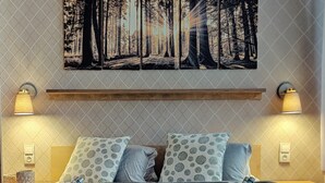 A neatly made bed with two pillows, a headboard, and two bedside lamps. - Penzion Bílá voda (Harrachov)