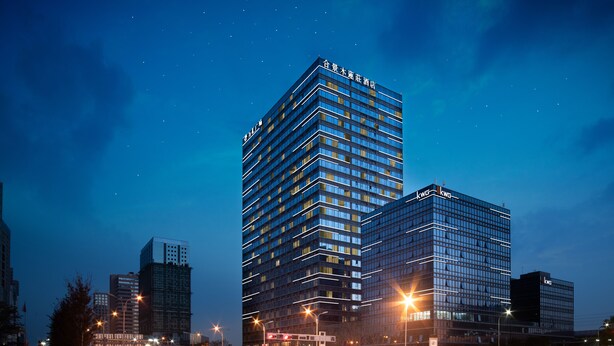 A modern high-rise hotel with multiple floors, large windows, and a prominent entrance. - The Mulian Hotel Suzhou Branch (Suzhou)