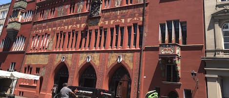 A historic building with a tall tower, arched windows, and intricate architectural details.