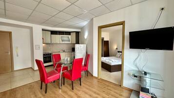 Classic Apartment, Pool View | Living room | 20-cm flat-screen TV with cable channels