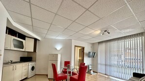 A compact living space with a kitchenette, dining area, and seating. - Menada Apartments in Sunny Beach Hills (Sunny Beach)