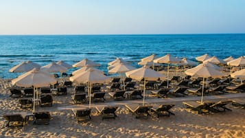 On the beach, sun-loungers, beach umbrellas, beach towels