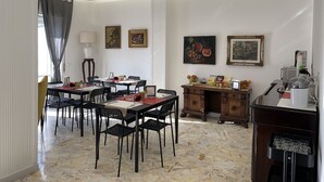 A dining area with a marble floor, a wooden cabinet, and a table set for six. - Di Palma Suite Museum (Naples)