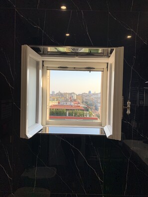 A room with a large window overlooking a cityscape. - Di Palma Suite Museum (Naples)