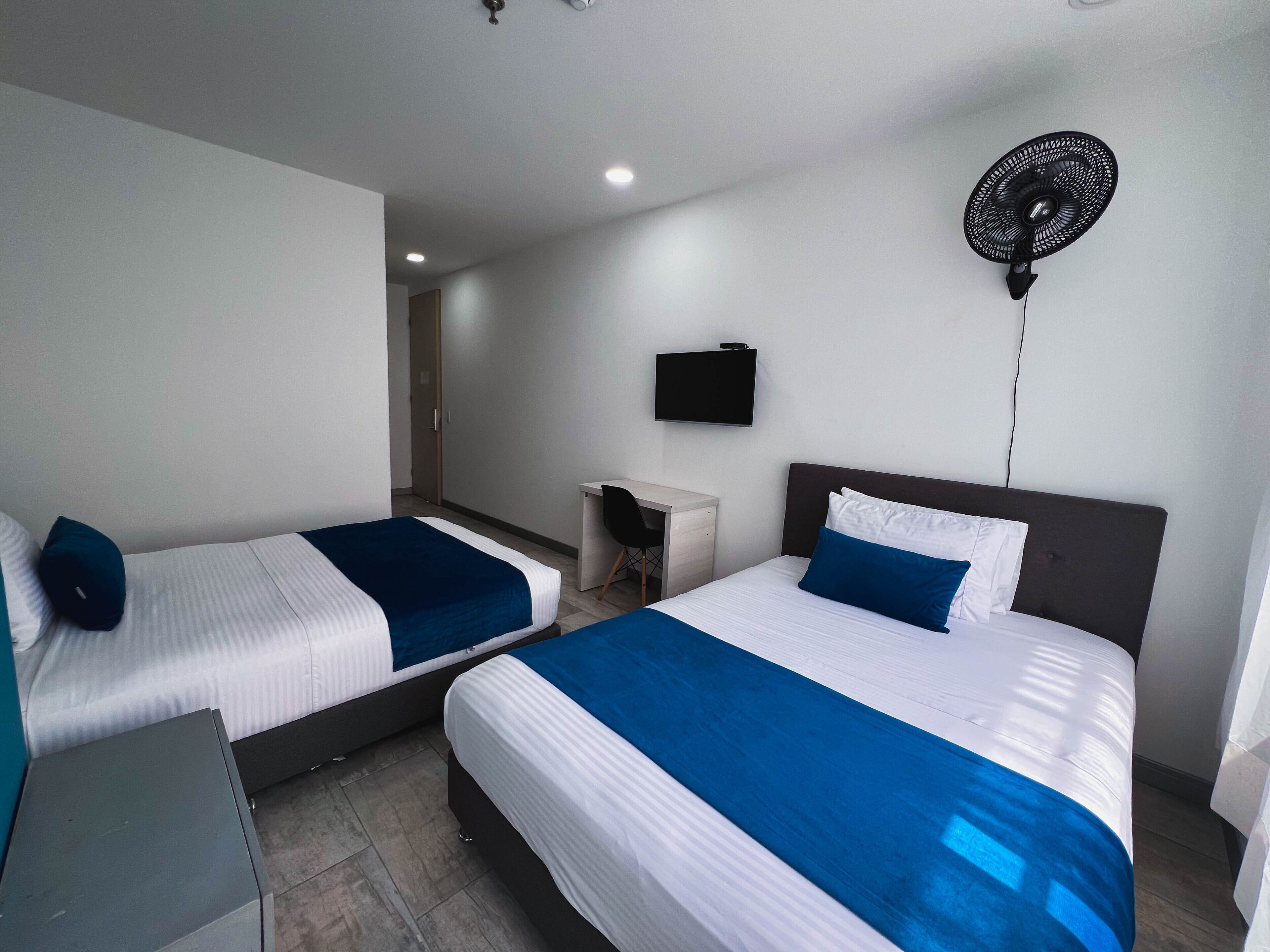 family room, multiple beds | in-room safe, desk, blackout curtains, iron/ironing board