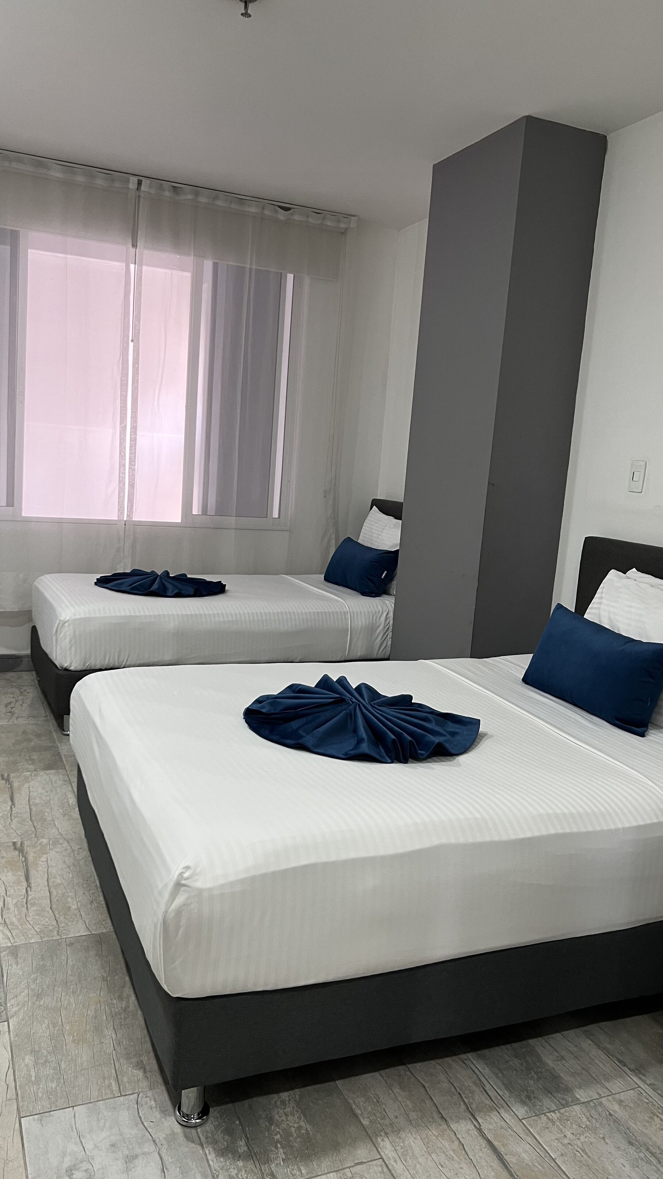 family room, multiple beds | in-room safe, desk, blackout curtains, iron/ironing board