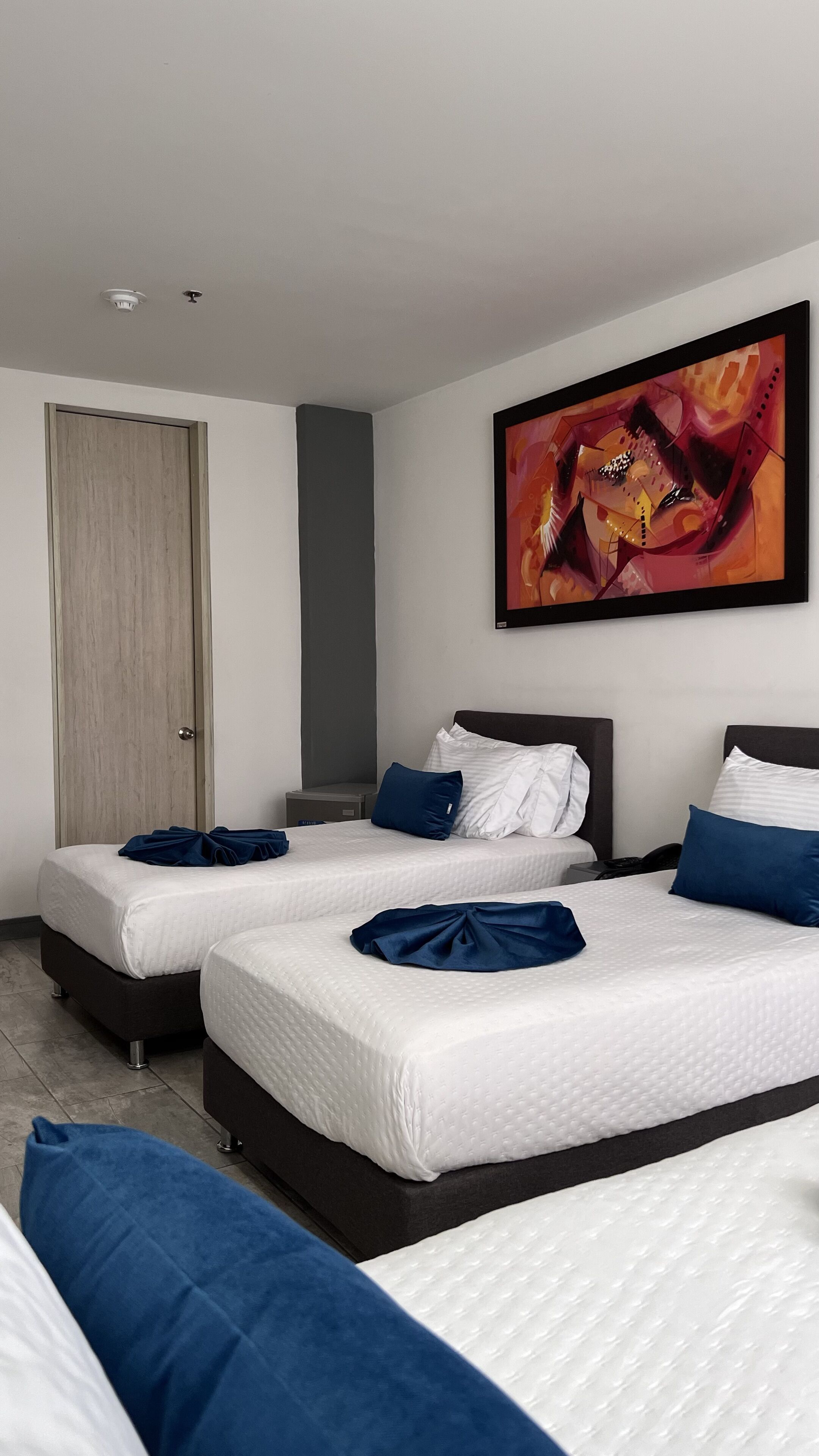 family room, multiple beds | in-room safe, desk, blackout curtains, iron/ironing board