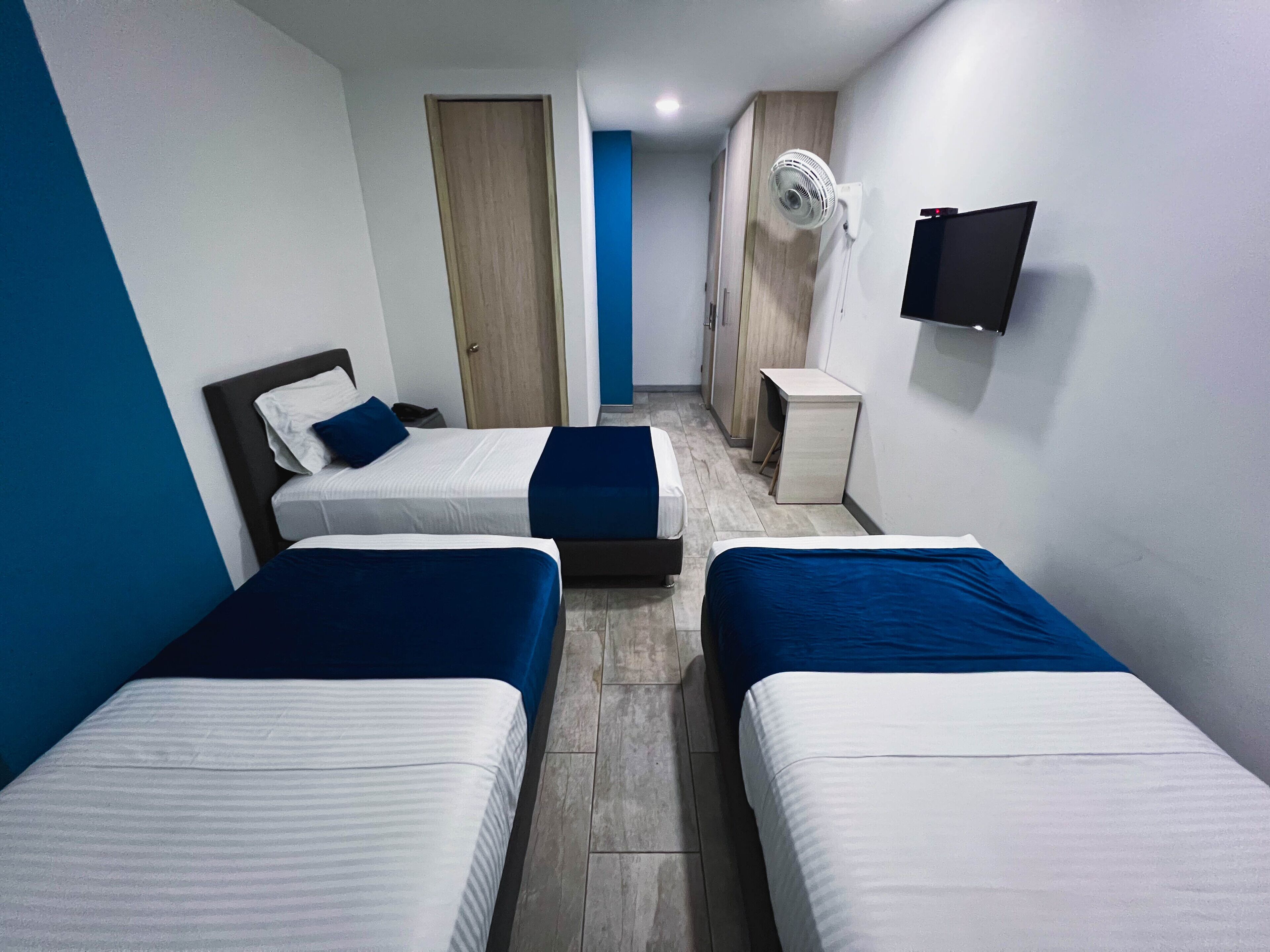 family room, multiple beds | in-room safe, desk, blackout curtains, iron/ironing board