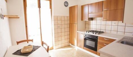 Apartment, 2 Bedrooms | Private kitchen | Full-size fridge, oven, stovetop, cookware/dishes/utensils