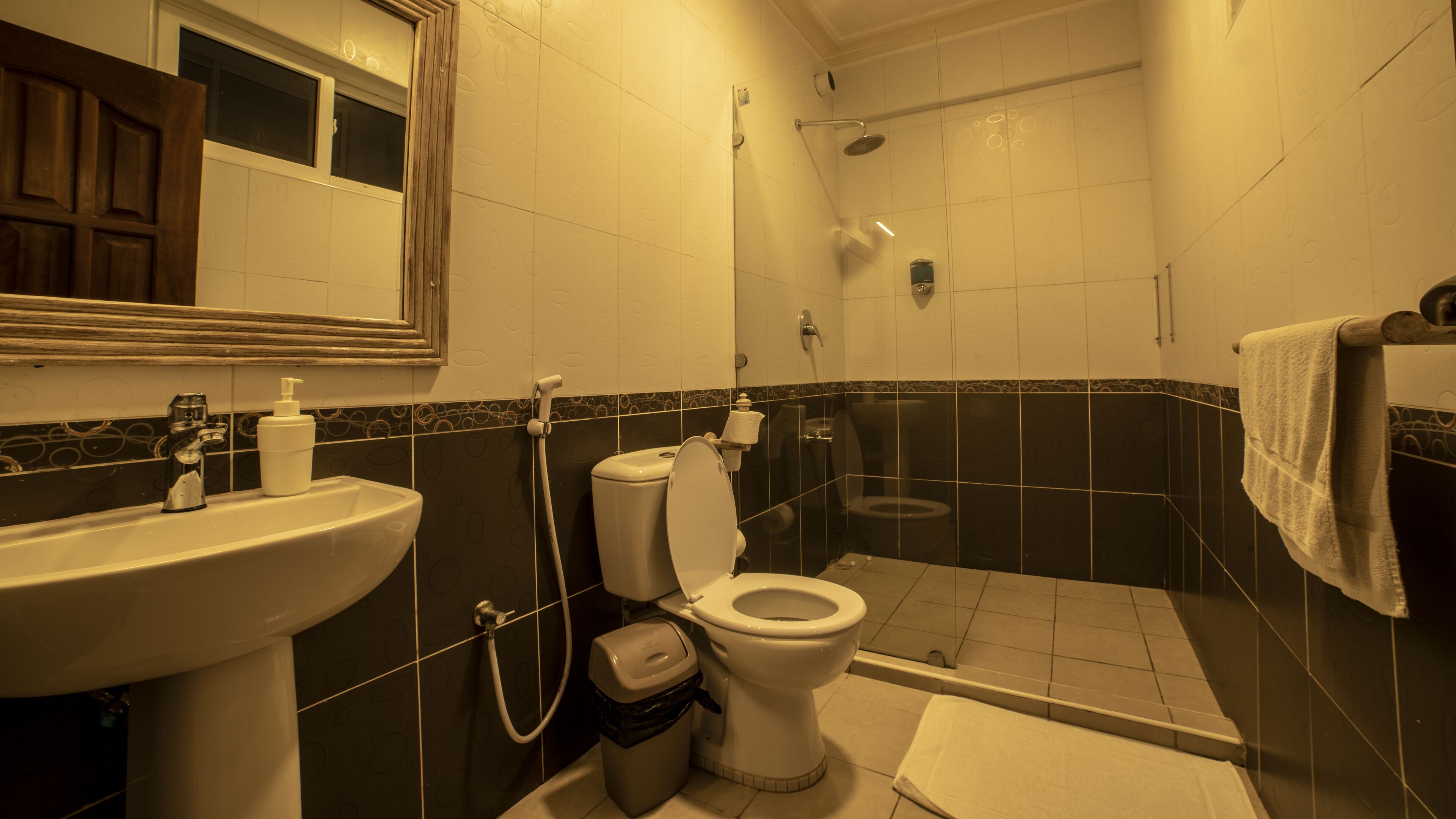 A bathroom with a sink, toilet, and shower.