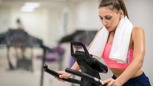 A person using an exercise machine in a gym with mirrors and other equipment in the background. - ibis Styles Athens Routes (Athens)