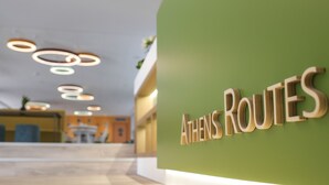 A reception area with a green wall and the sign "ATHENS ROUTES". - ibis Styles Athens Routes (Athens)