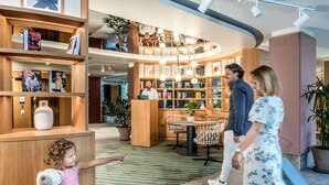 A lobby with a reception desk, seating area, and a children's play area.