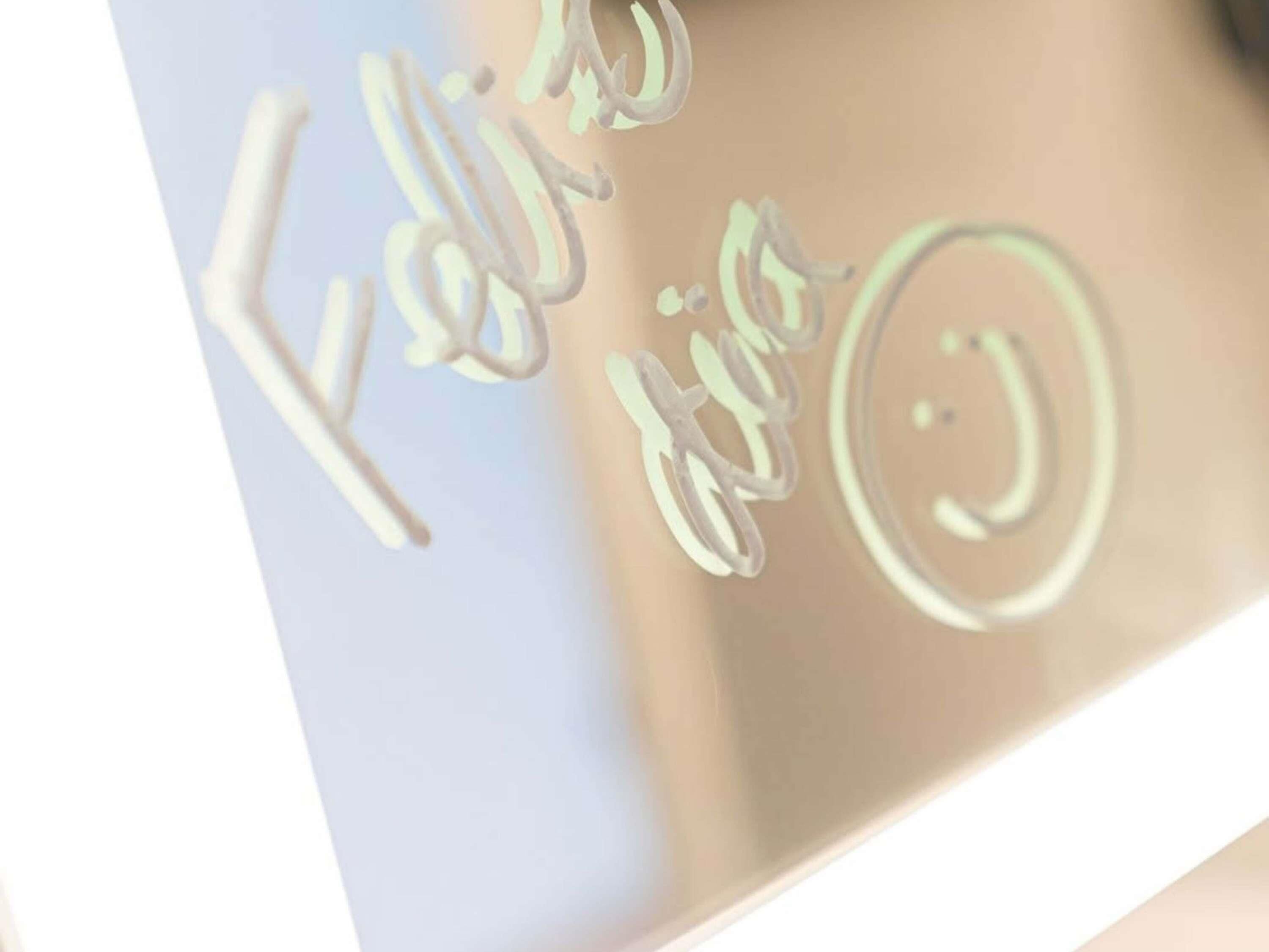 A metallic surface with engraved text and a circular symbol.