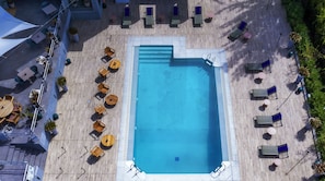 Seasonal outdoor pool, open 10:00 AM to 8:00 PM, pool umbrellas