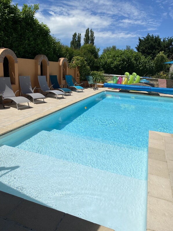 Seasonal outdoor pool, open 11:00 AM to 8:00 PM, pool umbrellas