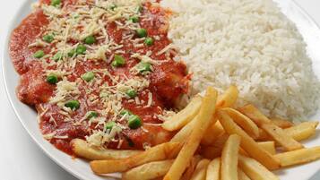 A plate with a serving of pasta, rice, and French fries.