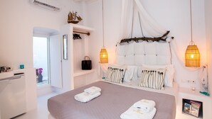 Ein Schlafzimmer mit einem großen Bett, Nachttischlampen, einem Kleiderschrank und einem Fenster mit Blick.