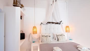A bedroom with a bed, bedside tables, a wardrobe, and a hanging chair.