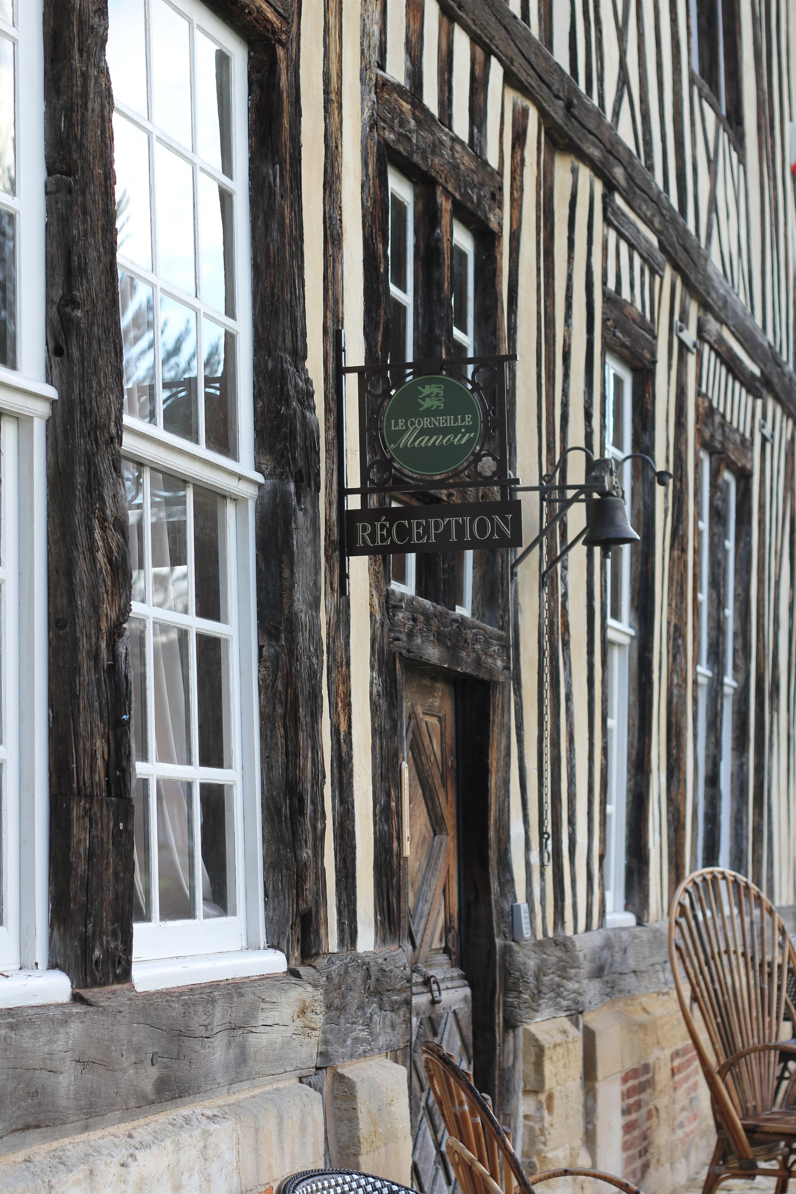 A traditional building with a reception sign and large windows.