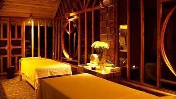 Cozy retreat with two single beds, wooden ceiling, and a stone wall, offering a cabin-like atmosphere.