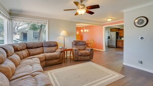 A living room with a sectional sofa, a recliner, a coffee table, and a ceiling fan. - Pueblo House by Riverwalk, 2 Miles to Fairgrounds! (Pueblo)