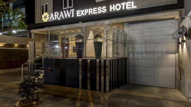 The exterior of the Arawi Express Hotel with a modern facade, large potted plants, and a visible entrance. - Arawi Miraflores Express (Lima)