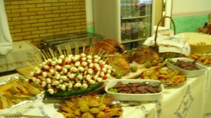 A buffet table with various food items including skewers, salads, and meat dishes. - Hotel Bellevue (Cesenatico)