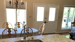 A kitchen with granite countertops, wooden cabinets, a double sink, and a dishwasher. - Sunset View Estate, a farm setting, upscale house. (Cosby)