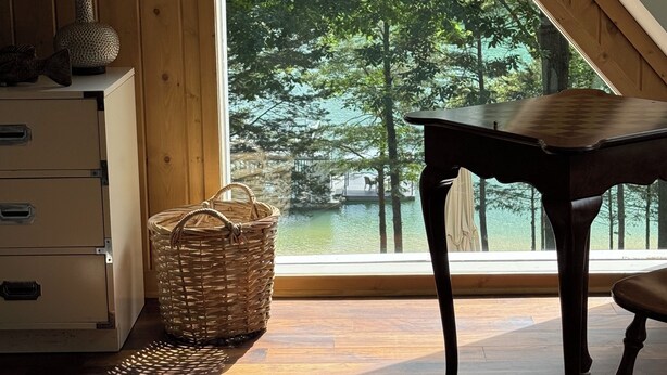 A room with a large window, a wooden desk, a wicker basket, and a white cabinet. - NORRIS LAKE FRONT RENTALS : CAMP RUN A MUK-LAKE FRONT with PRIVATE DOCK (Lafollette)