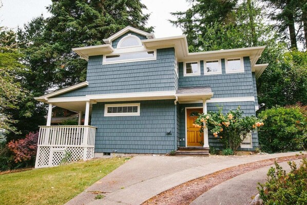 A two-story house with a porch and a front door.