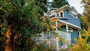 A two-story house with a porch and a white picket fence. - Perfect for an anniversary trip! (Lakebay)