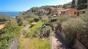 A coastal residential area with houses, a garden, and a view of the sea. - CASA MARGOT (RELAX WITH VISTA), independent, 300mt from the sea and the beach (Isola del Giglio)