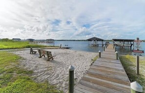 A beach with wooden walkways and benches.