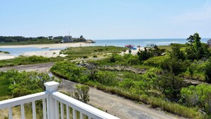 A coastal road with a beach view, a dirt path, and a white fence. - Three bedroom sleeping 6 just 150 steps to South Village Beach (West Dennis)
