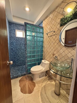 Shower, hair dryer, towels, toilet paper