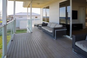 Relax on the spacious balcony with a sofa and table, taking in the views of the surrounding landscape.