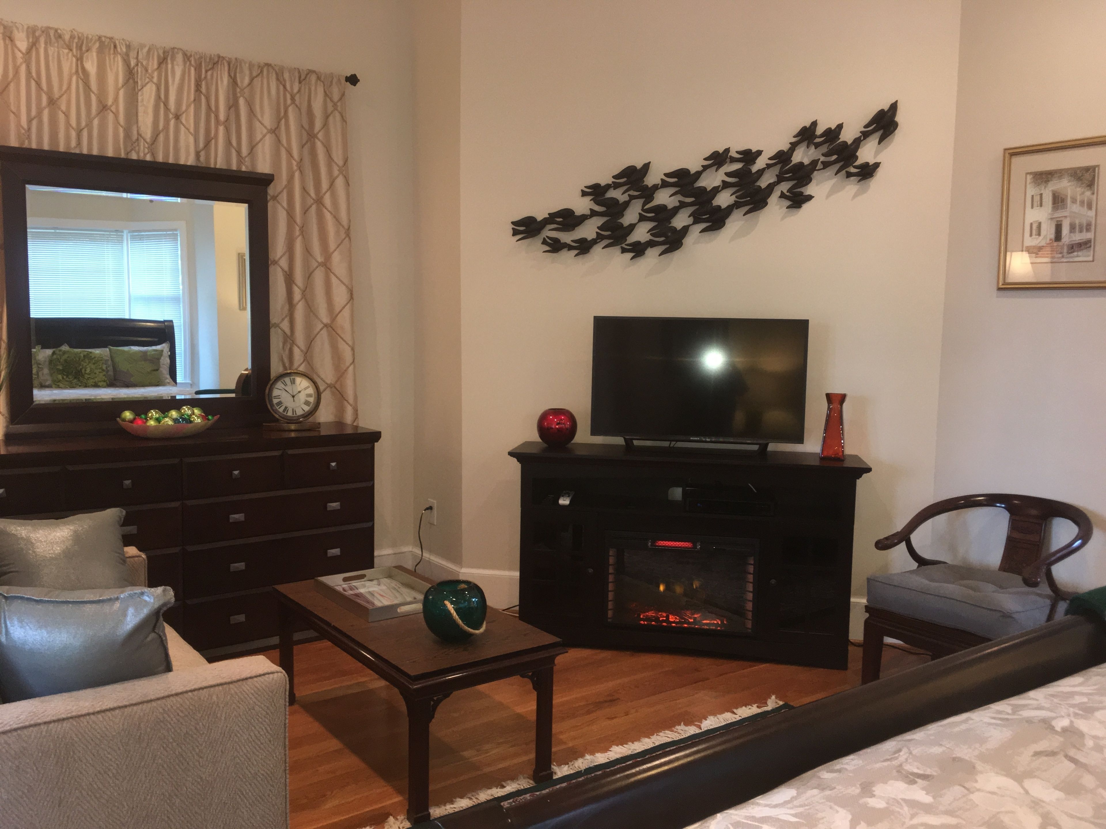 A living room with a fireplace, a television, and a sofa.